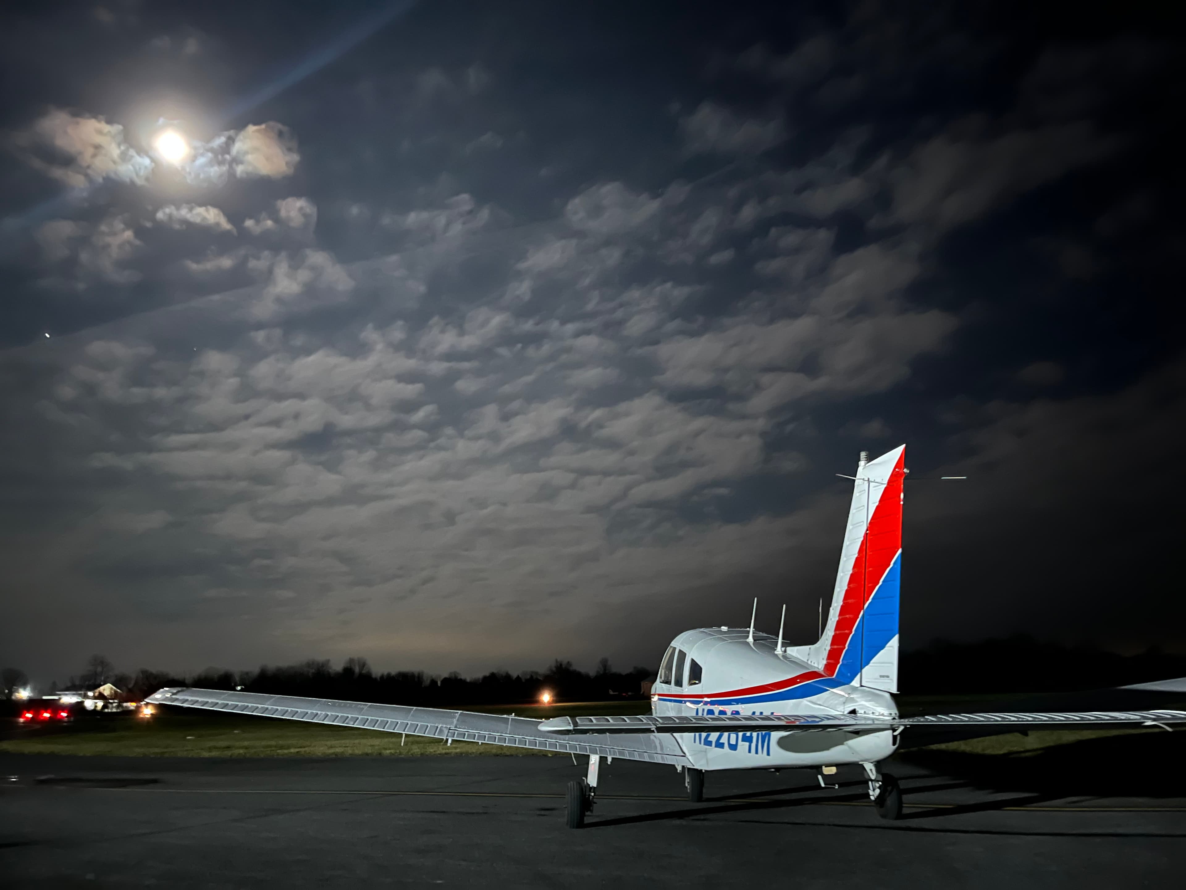 Piper Archer N2264M parked on the ramp at dusk